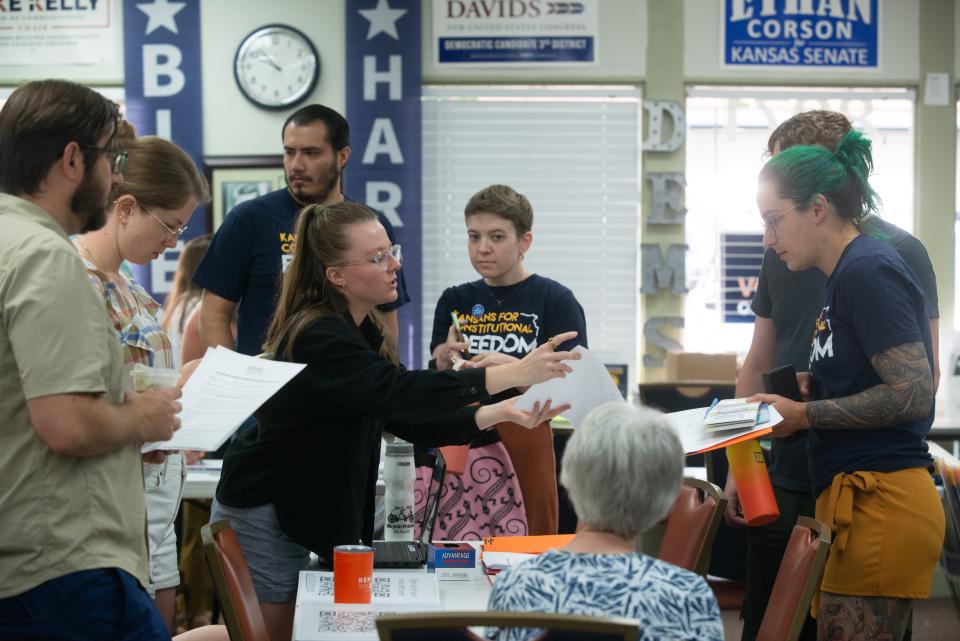 Young volunteers fill out paperwork to help canvas in opposition to a proposed abortion amendment to the Kansas Constitution in June in Overland Park.