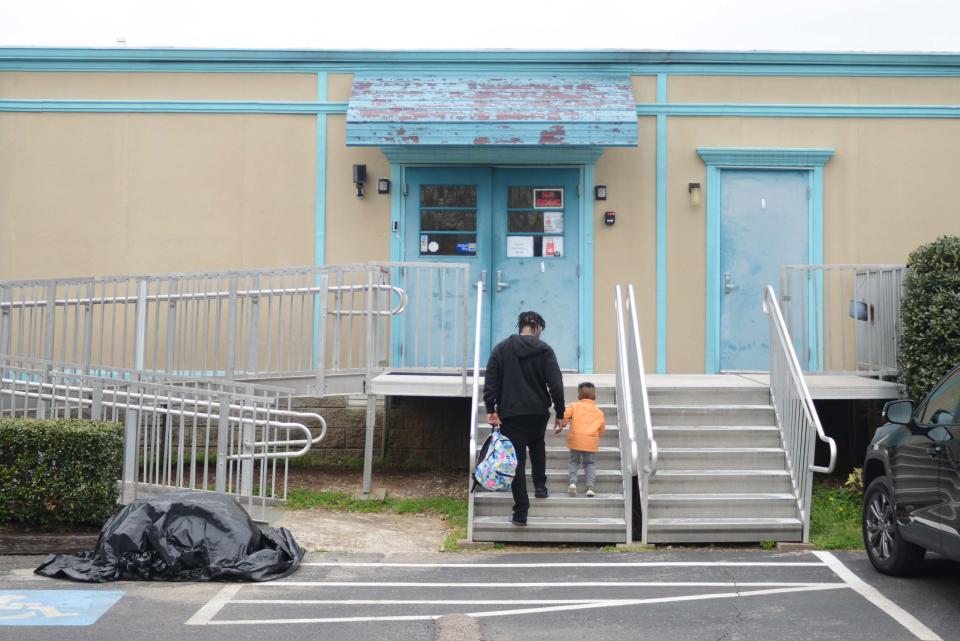 A guardian walks their child up the steps to Hands Up Preschool in Jackson, Tenn. on Thursday, March 7, 2024. Hands Up Preschool is one of two childcare facilities to be awarded grants for building upkeep and repair.