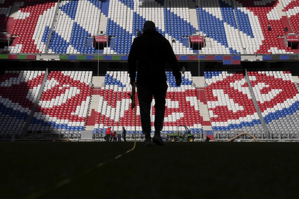 Workers prepare the FC Bayern Munich soccer stadium Allianz Arena in Munich, Germany, Wednesday, Nov. 9, 2022. The Tampa Bay Buccaneers are set to play the Seattle Seahawks in an NFL game at the Allianz Arena in Munich on Sunday. (AP Photo/Matthias Schrader)