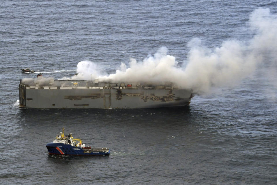 Smoke and flames are seen on a freight ship in the North Sea, about 27 kilometers (17 miles) north of the Dutch island of Ameland, Wednesday, July 26, 2023. A fire on the freight ship Fremantle Highway, carrying nearly 3,000 cars, was burning out of control Wednesday in the North Sea, and the Dutch coast guard said it was working to save the vessel from sinking close to an important habitat for migratory birds. (Kustwacht Nederland/Coastguard Netherlands via AP)