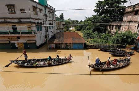People use boats as they try to move to safer places along a flooded street in West Midnapore district, in West Bengal. REUTERS/Rupak De Chowdhuri