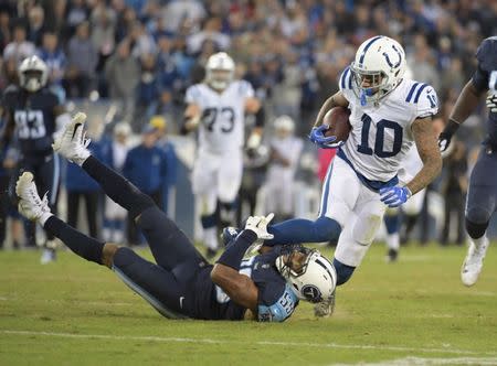 Oct 16, 2017; Nashville, TN, USA; Indianapolis Colts wide receiver Donte Moncrief (10) is tackled by Tennessee Titans linebacker Wesley Woodyard (59) at Nissan Stadium. The Titans defeated the Colts 36-22. Mandatory Credit: Kirby Lee-USA TODAY Sports