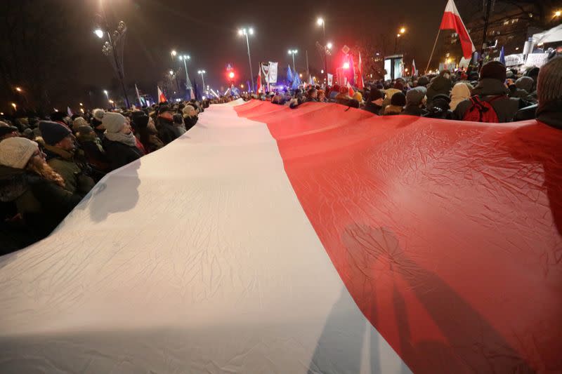 People take part in an anti-government protest in support of free judiciary in Warsaw