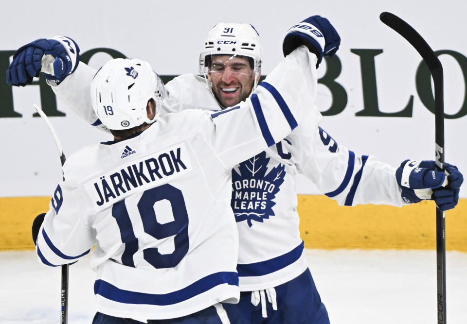 Toronto Maple Leafs' John Tavares (91) celebrates with Calle Jarnkrok after scoring against the Montreal Canadiens during the third period of an NHL hockey game Saturday, March 9, 2024, in Montreal. (Graham Hughes/The Canadian Press via AP)