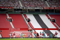 FILE - In this Saturday, July 4, 2020 file photo, empty stands are seen as Manchester United's Paul Pogba (6) shoots a free kick during their English Premier League soccer match against Bournemouth at Old Trafford stadium in Manchester, England. Much to the Premier League’s dismay, the new season will start on Saturday, Sept. 12 just as the last one finished only 48 days earlier — in empty stadiums. The world’s richest football league on Friday intensified its lobbying of the government to allow supporters back into games, even as England grapples with a sharp spike in coronavirus cases. (AP Photo/Dave Thompson, file)
