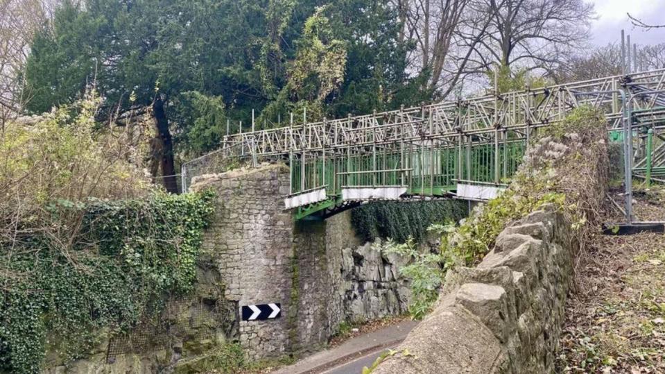 The footbridge covered in scaffolding