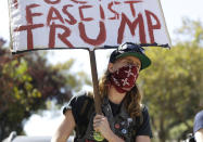 <p>A protester holds up a sign outside of Alamo Square Park in San Francisco, Saturday, Aug. 26, 2017. (Photo: Marcio Jose Sanchez/AP) </p>