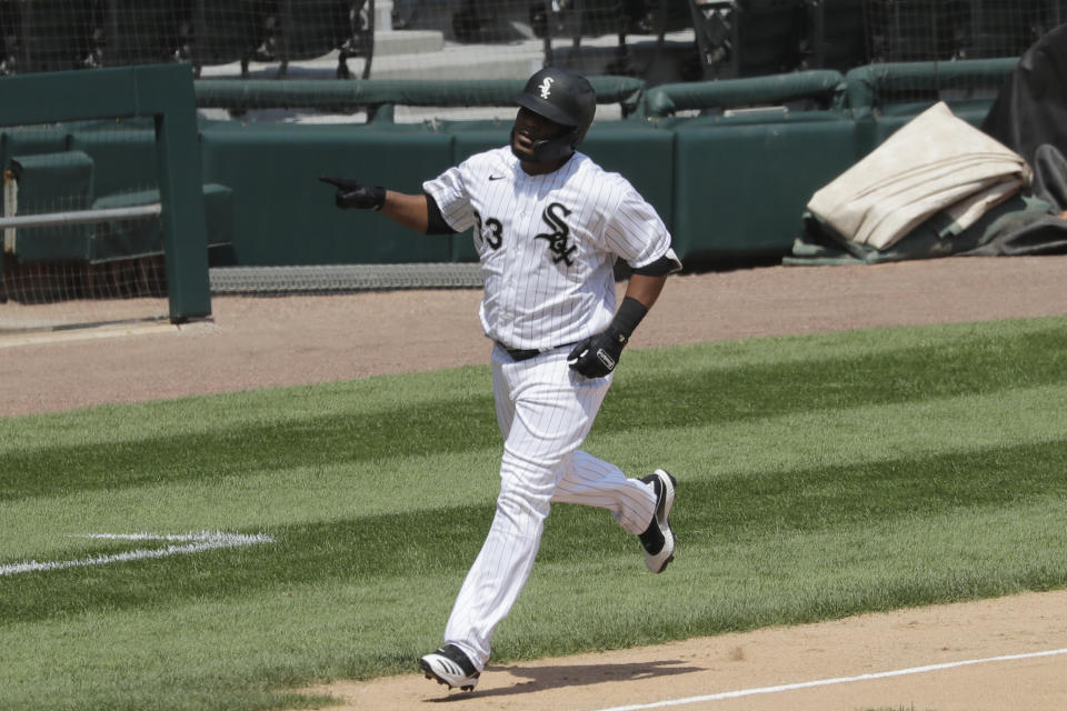 Chicago White Sox's Edwin Encarnacion points as he rounds the bases after hitting a two-run home run against the Minnesota Twins during the fifth inning of a baseball game in Chicago, Saturday, July 25, 2020. (AP Photo/Nam Y. Huh)