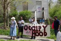 Vanessa Spark (L), a member of Occupy Cincinnati and Occupy the Hood addresses the crowd in front of a foreclosed home during a Occupy Cincinnati march in Cincinnati, Ohio March 24, 2012. Occupy activists across America say they have found a cause that represents an issue for the "99 percent" and embodies the movement's anti-Wall Street message: helping struggling homeowners fight foreclosure and eviction. Picture taken March 24, 2012.