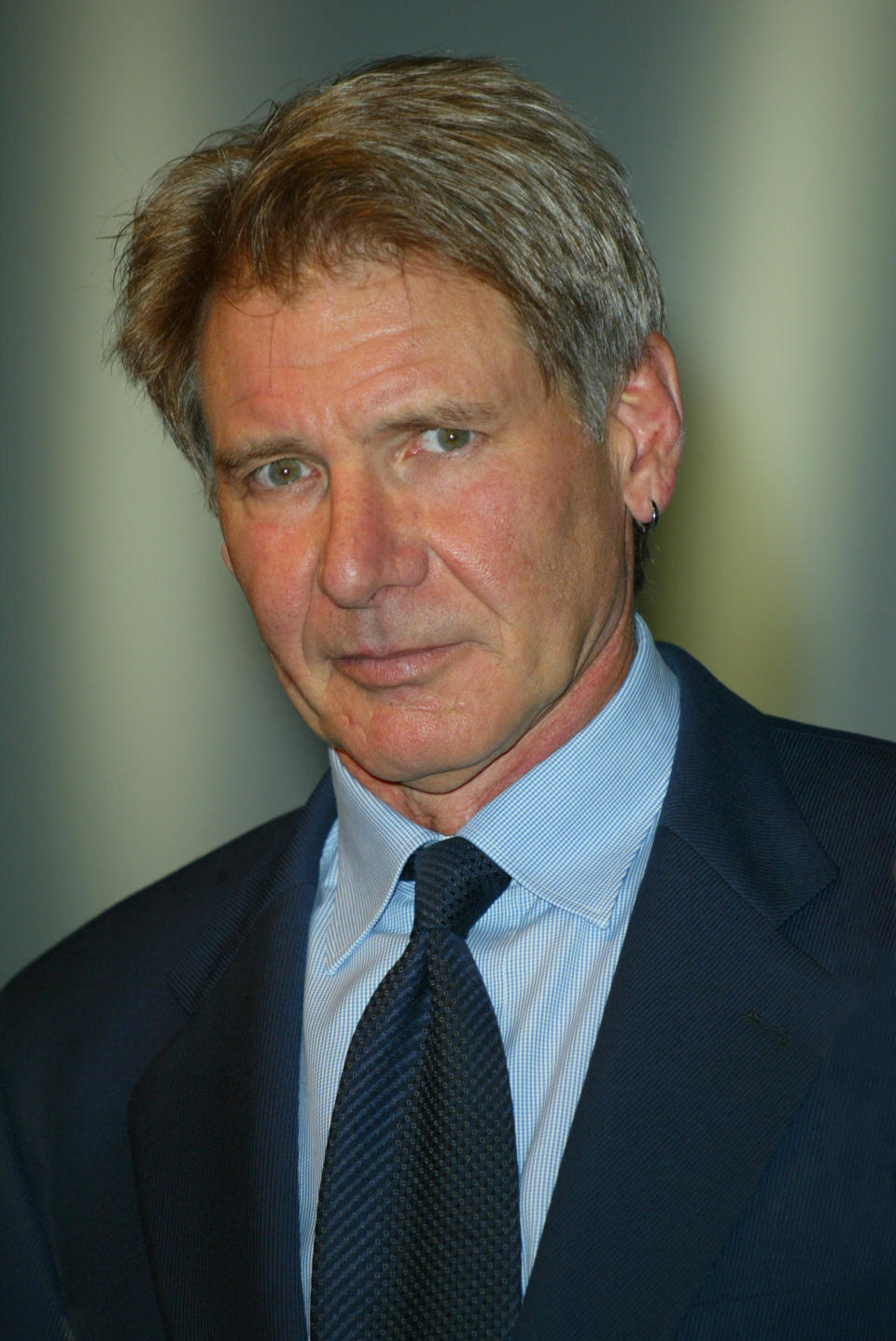 Close-up of Harrison in a suit and tie