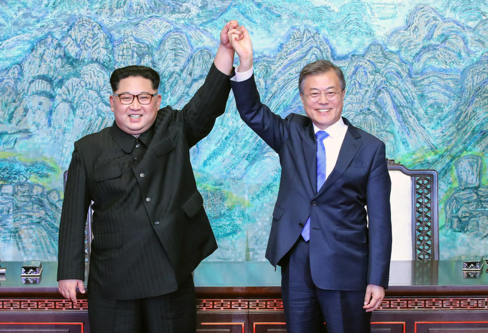 North Korean leader Kim Jong Un (L) and South Korean President Moon Jae-in (R) pose for photographs after signing the Panmunjom Declaration for Peace, Prosperity and Unification of the Korean Peninsula during the Inter-Korean Summit on April 27, 2018.