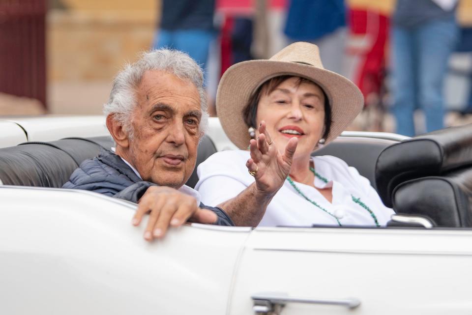 Parade marshals Anna Marie and Tom Giodone wave to spectators during the Colorado State Fair Parade on Saturday, August 26, 2023.