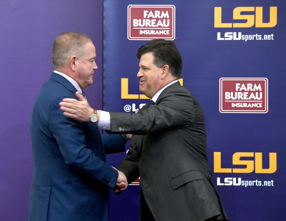 Dec 1, 2021; Baton Rouge, LA, USA; Newly named LSU Tigers head football coach Brian Kelly (left) is introduced by athletic director Scott Woodward (right) in a press conference at Tiger Stadium. Mandatory Credit: Patrick Dennis-USA TODAY Sports