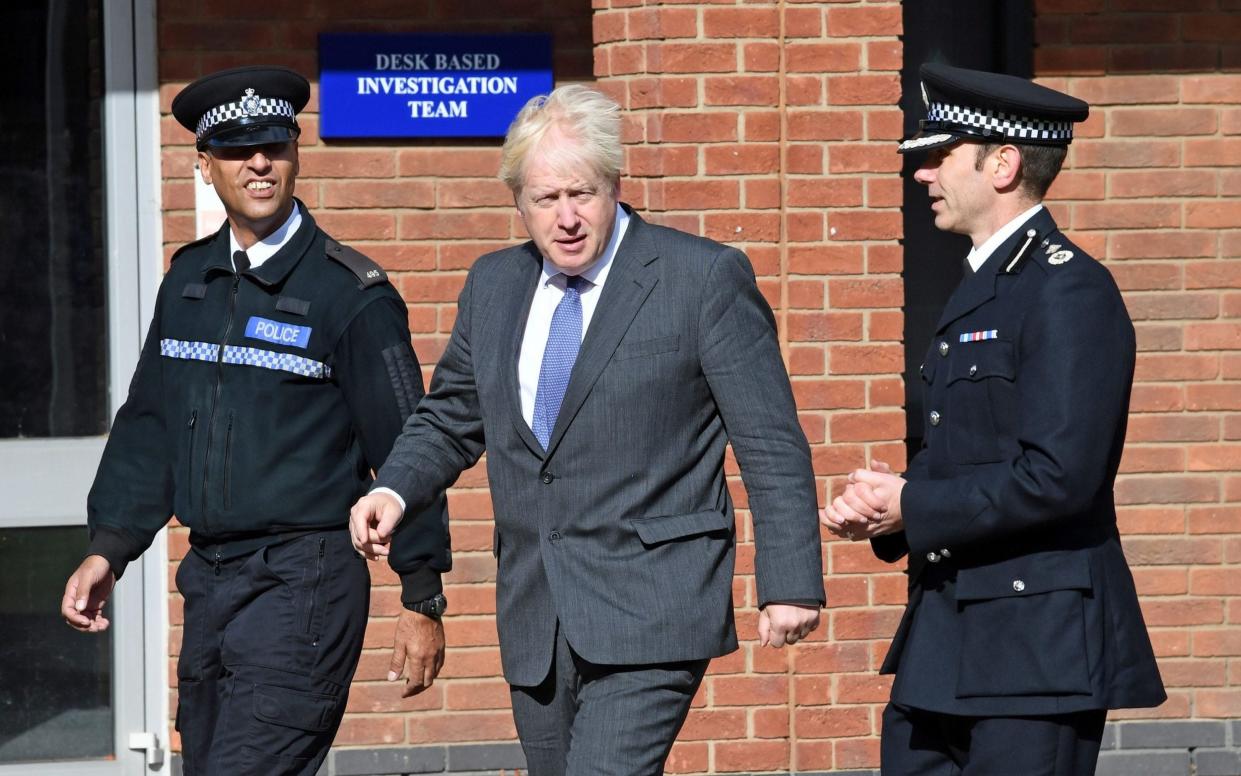 Boris Johnson visiting Northamptonshire police last year - Pool/Reuters