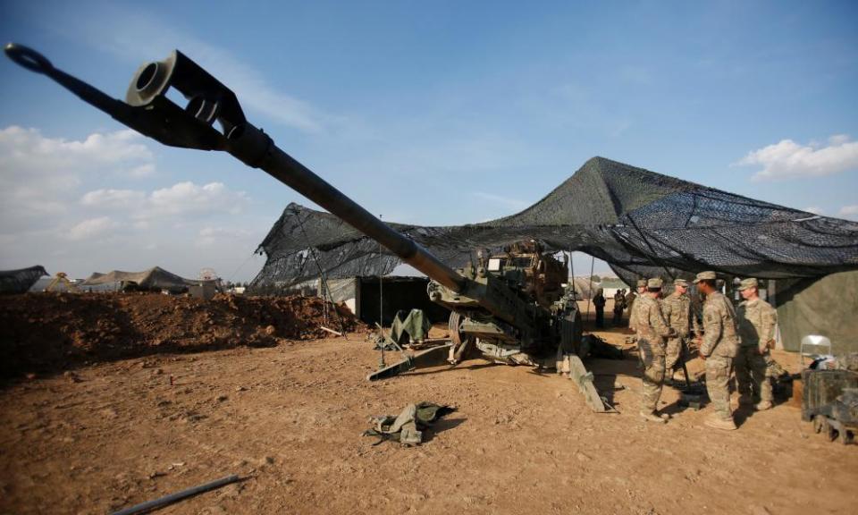 US soldiers from the 2nd Brigade, 82nd Airborne Division gather around an artillery at a military base north of Mosul, Iraq, on 14 February.