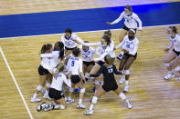 Kentucky rushes the court celebrating a win over Washington in four sets during a semifinal in the NCAA women's volleyball championships Thursday, April 22, 2021, in Omaha, Neb. (AP Photo/John Peterson)