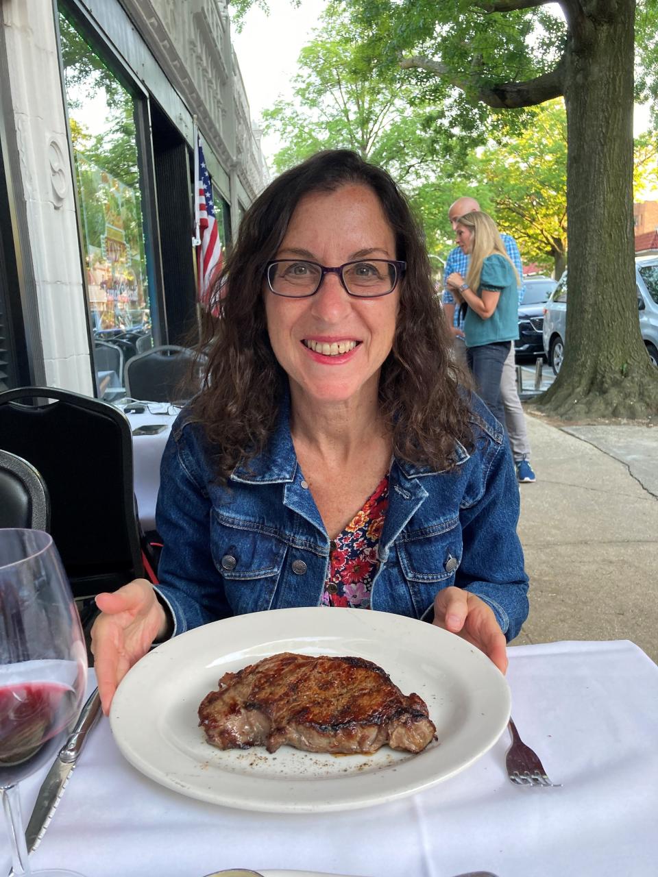 Lohud Food & Dining Reporter Jeanne Muchnick with a New York strip at Macelleria Italian Steakhouse in Pelham. Photographed June 4, 2022.