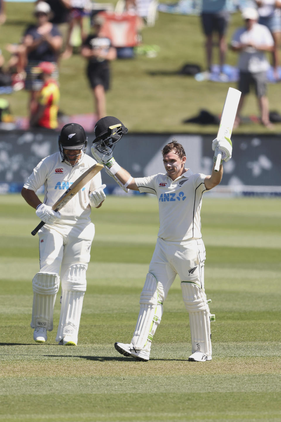 Tom Latham of New Zealand celebrates his 200 runs on day two of the second cricket test between Bangladesh and New Zealand at Hagley Oval in Christchurch, New Zealand, Monday, Jan. 10, 2022. (Martin Hunter/Photosport via AP)