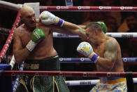 Britain's Tyson Fury, left, and Ukraine's Oleksandr Usyk trade blows during their undisputed heavyweight world championship boxing fight at the Kingdom Arena in Riyadh, Saudi Arabia, Sunday, May 19, 2024. (AP Photo/Francisco Seco)