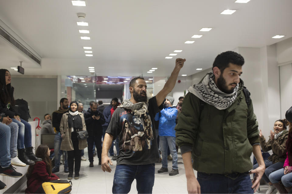 Anti-government protesters occupy the Hamra branch of BLC Bank Dec. 28, 2019 in Beirut, Lebanon. Banks have imposed weekly limits on withdrawals of U.S. dollars amid a shortage in liquidity and as the country grapples with its worst economic and financial crisis since the end of the 1975-90 civil war. The country has been without a prime minister since ongoing mass protests forced the resignation of Premier Saad Hariri on Oct. 29. (AP Photo/Maya Alleruzzo)