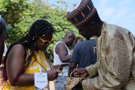 U.S. tourist Teresa Arthur looks at bracelets while on tour at the Kwame Nkrumah Mausoleum in Accra