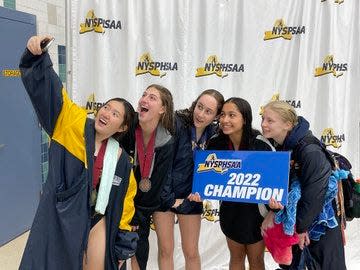 NYSPHSAA diving champion Rachel Yang takes a selfie with her fellow divers Friday at the Webster Aquatic Center.