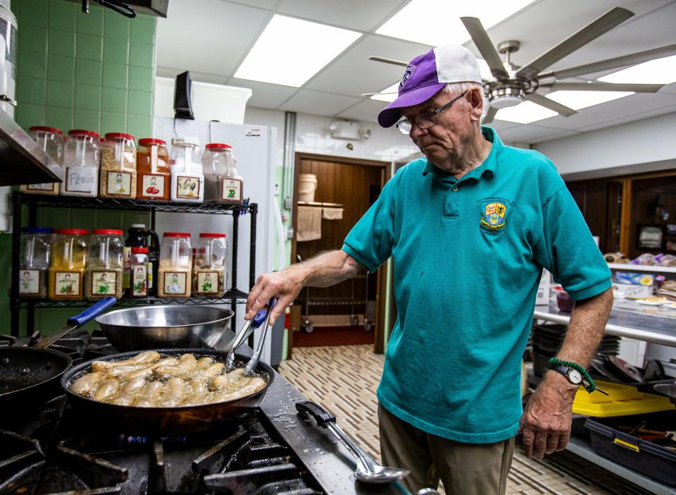 Juergen Sell cooks Bratwurst in the German-American Club kitchen during a recent lunch rush at their Audobon neighborhood location. Jergen moved to America with his wife Bengta Sell in 1979 and has worked at the club ever since. September 1, 2022