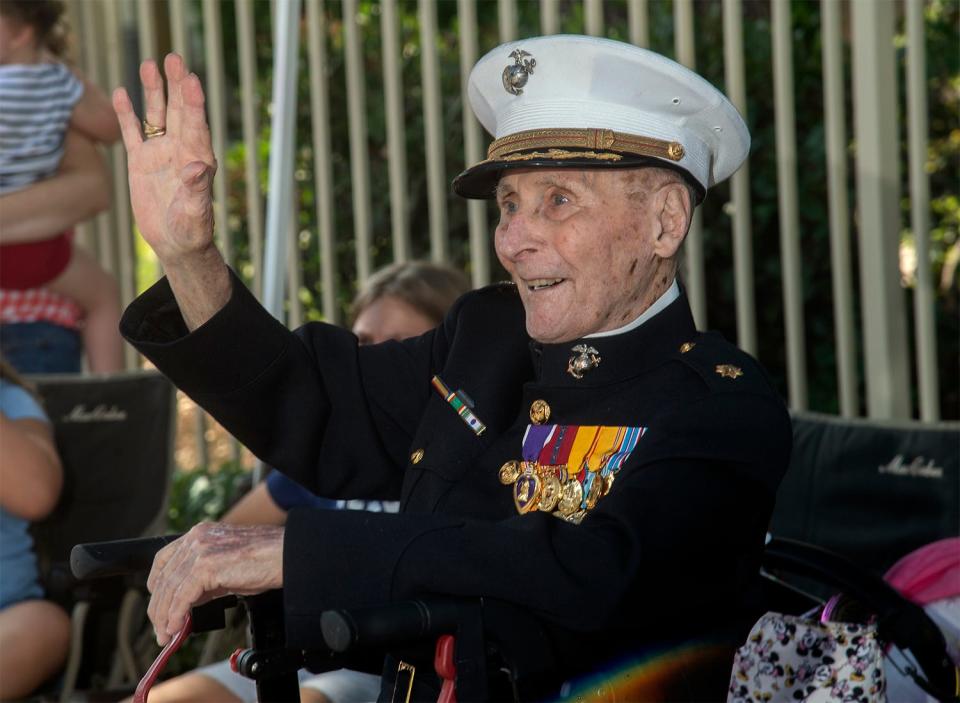 Retired USMC Major Bill White waves to well-wishers in their cars as they parade by for his 106th birthday at the Oaks at Inglewood retirement community in Stockton. White, a WWII veteran, thanked and waved to drivers and passengers as they wished him a Happy Birthday. In 2020 White started Operation Valentines by asking people to send him cards on Valentine's Day. He received hundreds of thousands of cards from all around the world. 