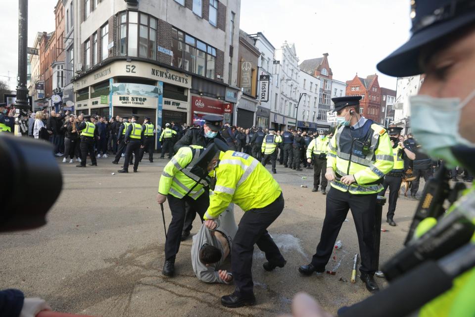 <p>Gardai restrain a protester during an anti-lockdown protest in Dublin city centre.</p> (PA)