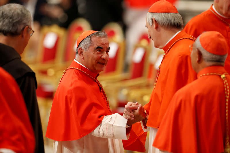 FILE PHOTO: Cardinal Angelo Becciu greets Cardinal Matteo Zuppi
