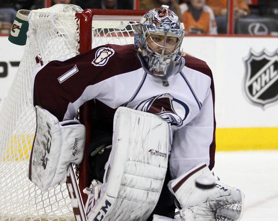 Colorado Avalanche goalie Semyon Varlamov watches the puck heading to his glove by a shot from Philadelphia Flyers' Brayden Schenn during the second period of an NHL hockey game, Thursday, Feb. 6, 2014, in Philadelphia. (AP Photo/Tom Mihalek)