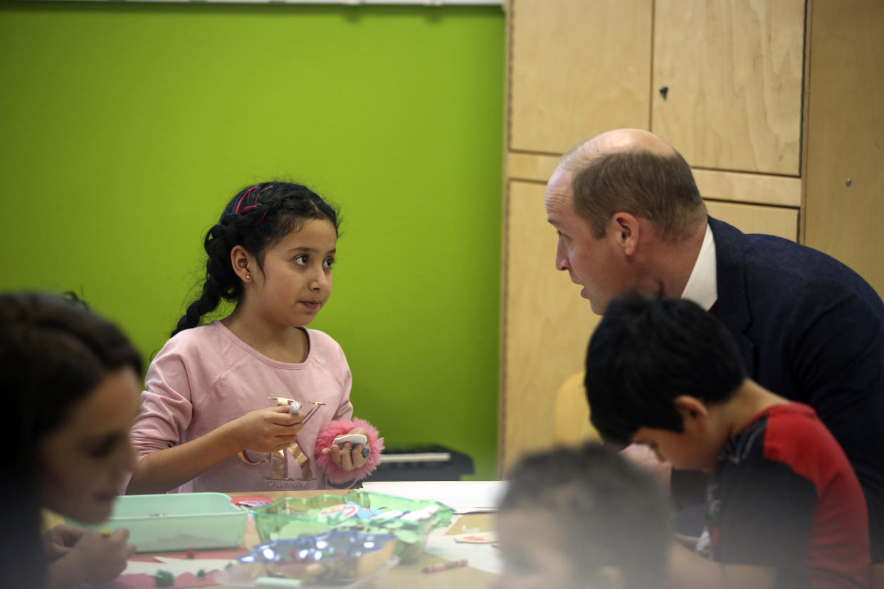 Britain's Prince William chats with a child in Roca's Young Mother's Program Thursday, Dec. 1, 2022, in Chelsea, Mass. (AP Photo/Reba Saldanha, Pool)