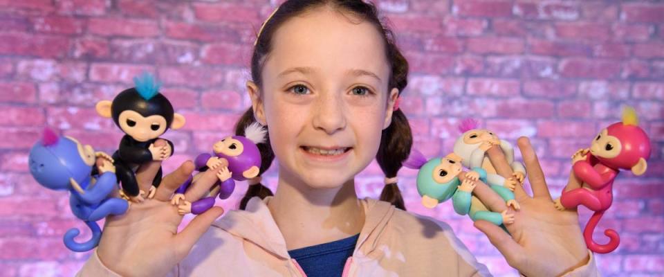 Young girl holds Fingerlings on her fingers