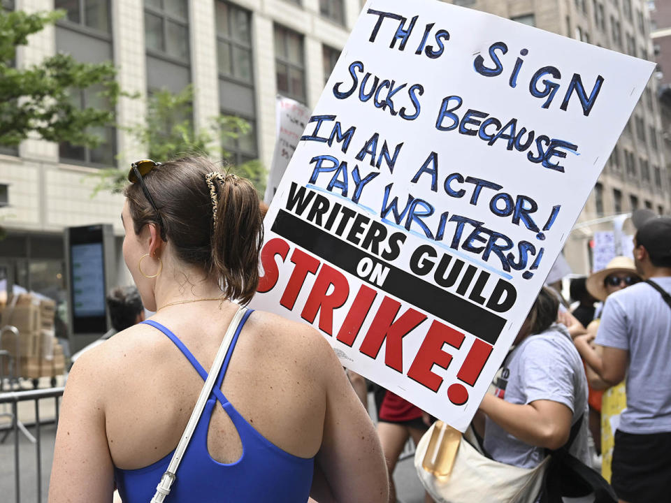 Members of the Writers Guild of America East are joined by SAG-AFTRA members as they picket outside the Warner Bros. Discovery office in New York City on July 13, 2023. / Credit: Fatih Aktas/Anadolu Agency via Getty Images