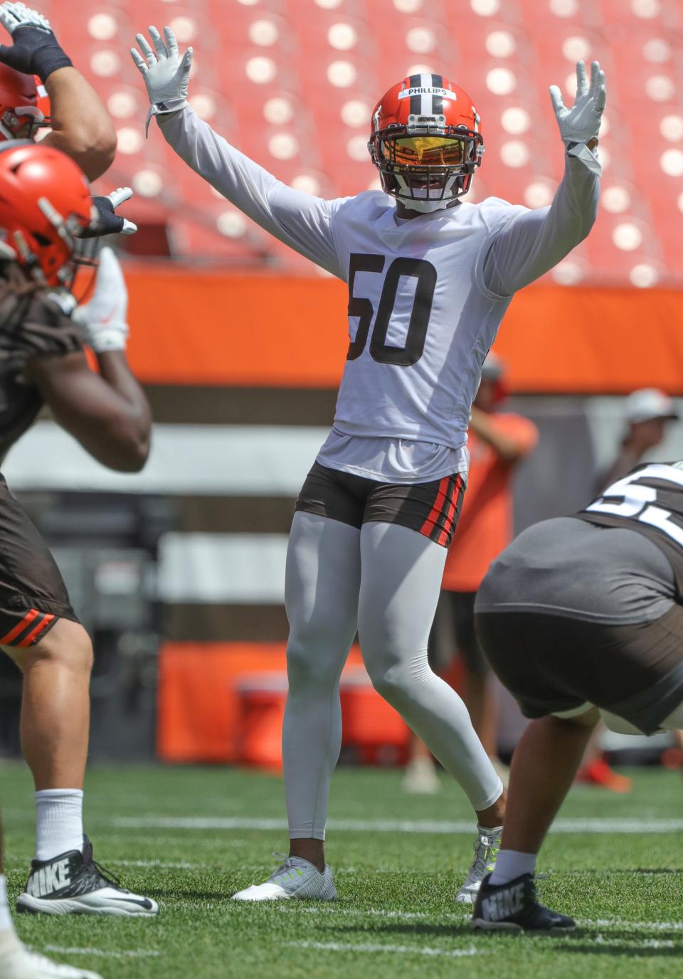 Cleveland Browns linebacker Jacob Phillips calls out a defensive signal during minicamp drills on June 16, 2022, in Cleveland.