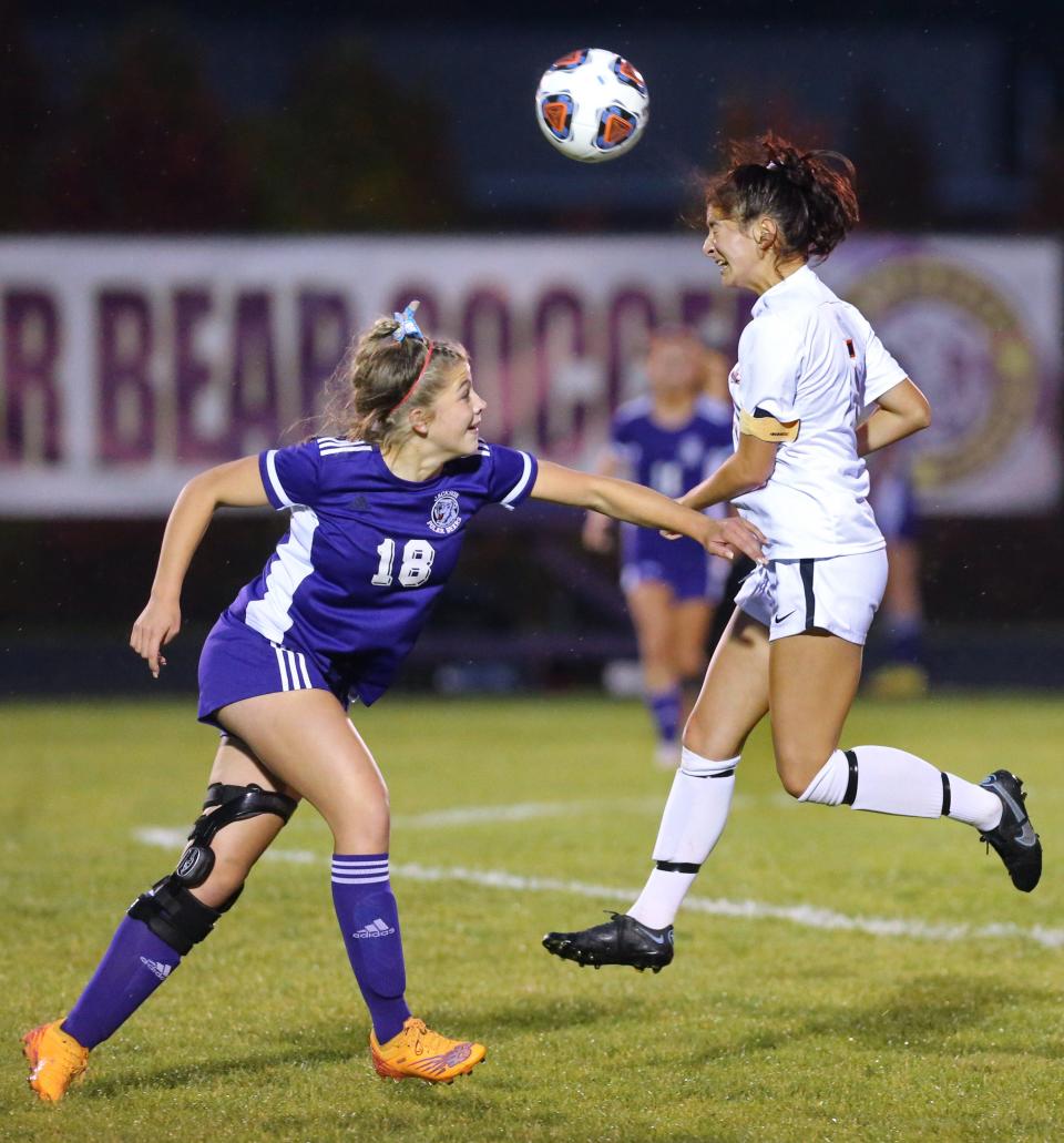 Green's Lauren Leemaster (right) goes for a header while being defended by Jackson's Emily Adams during a game this season.