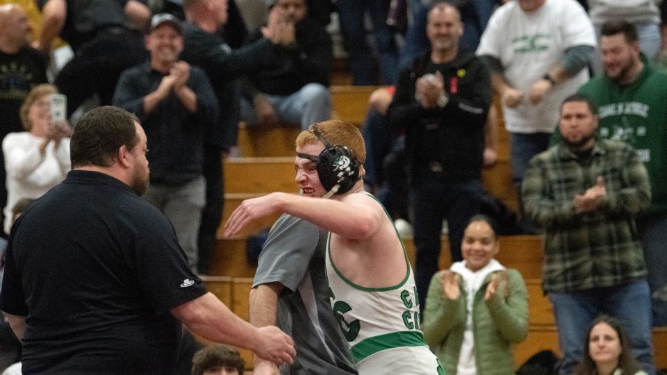 Camden Catholic's Jackson Young celebrates with his coaches after Young defeated Southern's Conor Collins, 3-2, in the 126 lb. championship bout of the Region 7 wrestling tournament at Cherry Hill East High School on Saturday, February 25, 2023.  