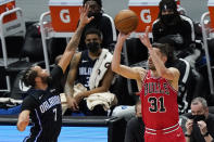 Chicago Bulls guard Tomas Satoransky, right, shoots against Orlando Magic guard Michael Carter-Williams during the first half of an NBA basketball game in Chicago, Wednesday, April 14, 2021. (AP Photo/Nam Y. Huh)