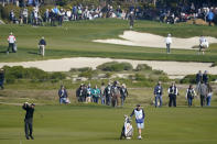 Phil Mickelson, lower left, hits a shot from the sixth fairway of the Monterey Peninsula County Club Shore Course during the second round of the AT&T Pebble Beach National Pro-Am golf tournament Friday, Feb. 7, 2020, in Pebble Beach, Calif. (AP Photo/Tony Avelar)