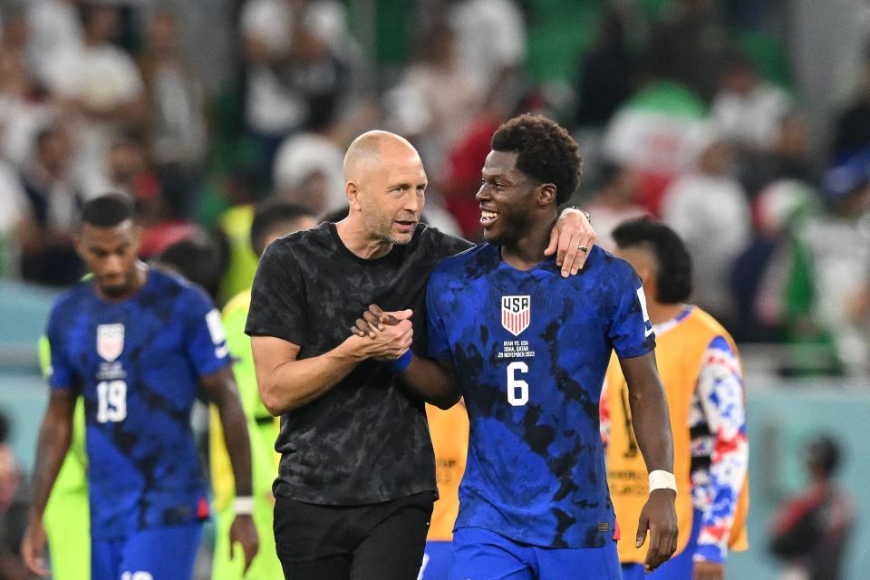 Gregg Berhalter celebrates with USA's Yunus Musah during the World Cup match with Iran.