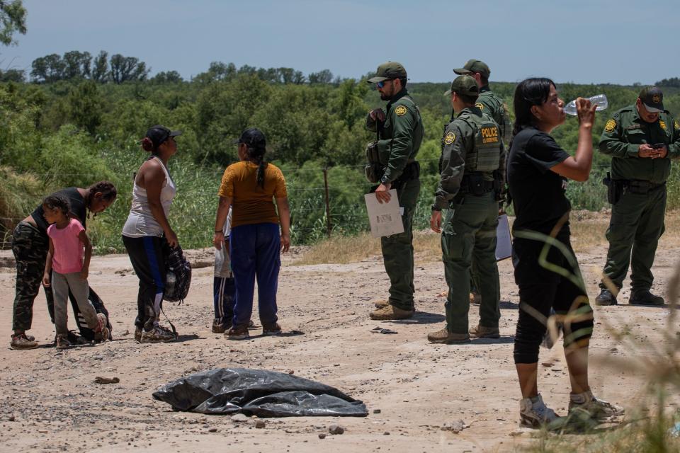 Migrants are counted by Border Patrol agents before being taken into federal custody about two miles east of where buoys were placed in the Rio Grande on Thursday, July 20, 2023, in Eagle Pass, Texas. 