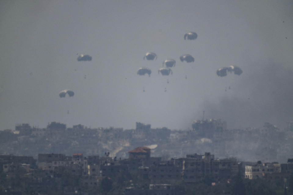 Parachutes drop supplies into the northern Gaza Strip as seen from southern Israel, Tuesday, April 9, 2024. (AP Photo/Leo Correa)