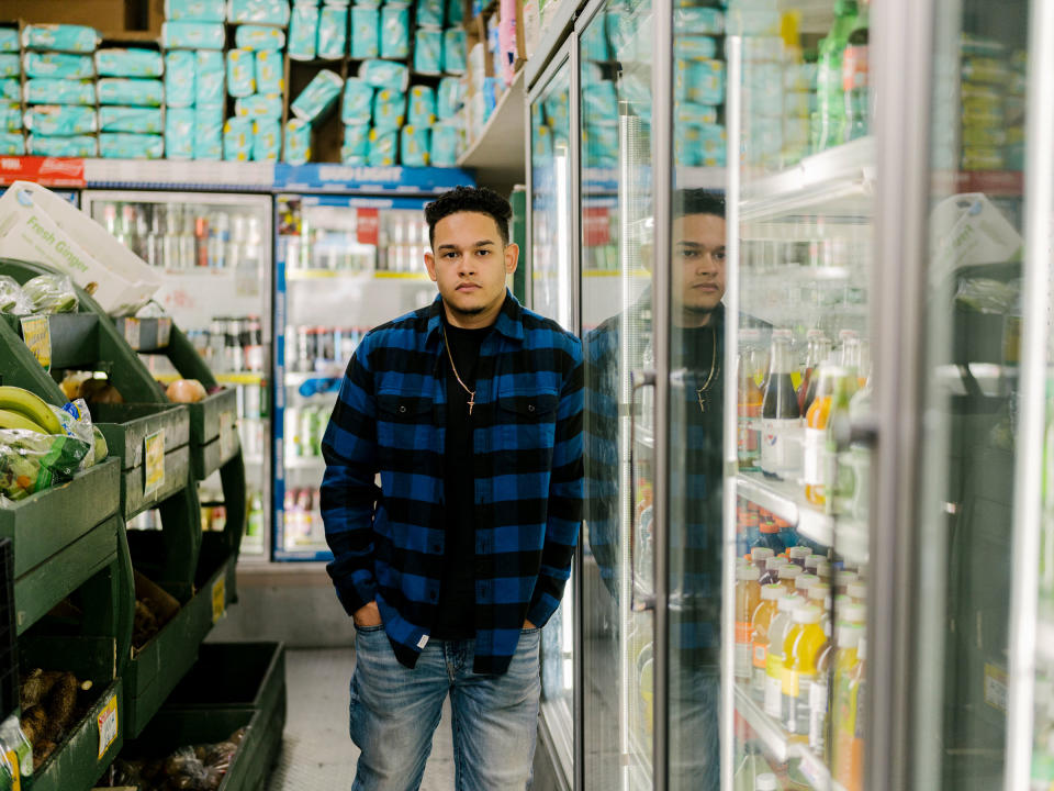 Jason Vargas, who hopes of join the NYPD, poses for a portrait at his father’s deli in the Bronx.<span class="copyright">Elias Williams</span>