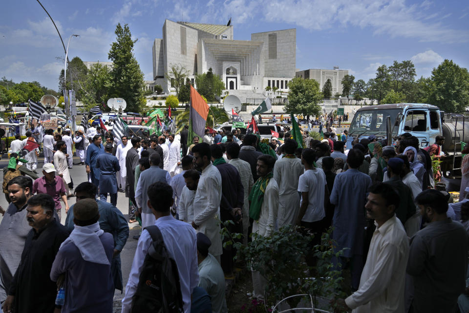 Supporters of Pakistan Democratic Movement, an alliance of the ruling political parties, take part in a rally outside the Supreme Court in Islamabad, Pakistan, Monday, May 15, 2023. Convoys of buses and vehicles filled with Pakistani pro-government supporters are flooding the main road leading to the country's capital on Monday to protest the release of former Prime Minister Imran Khan. (AP Photo/Anjum Naveed)