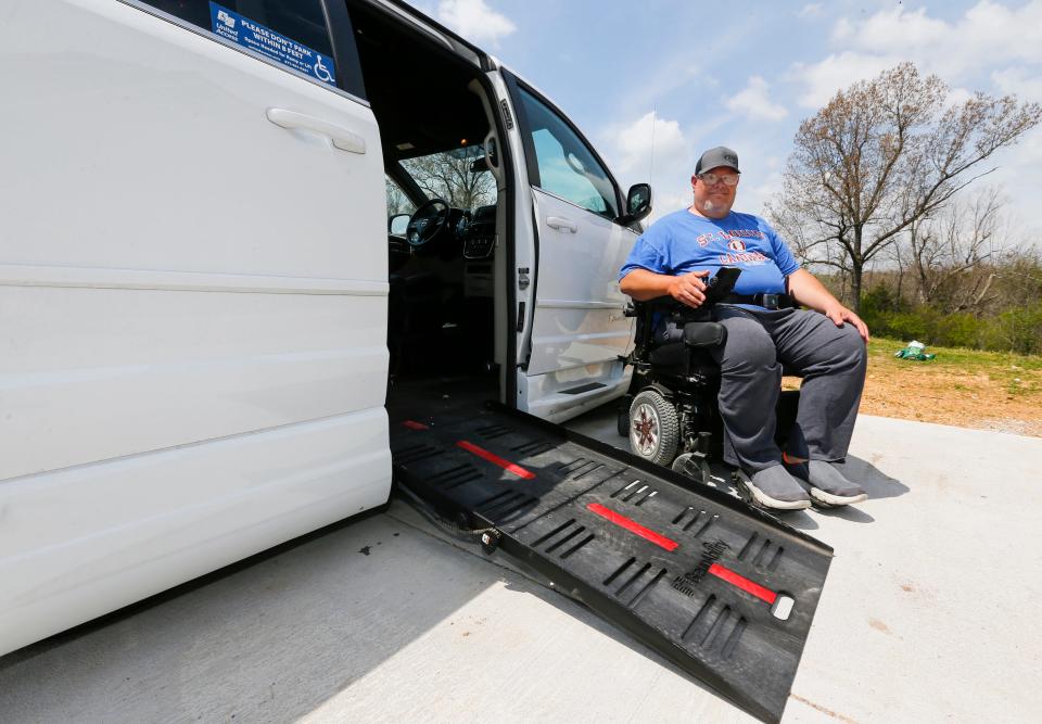 Jason Wendlandt next to his handicap-accessible van after a car accident last fall that left him paralyzed from the waist down.