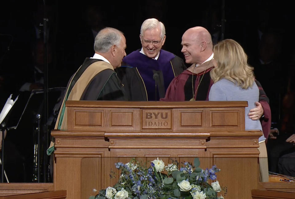 Elders Ronald A. Rasband, left, and D. Todd Christofferson congratulate new BYU-Idaho President Alvin F. Meredith and his wife, Jennifer.