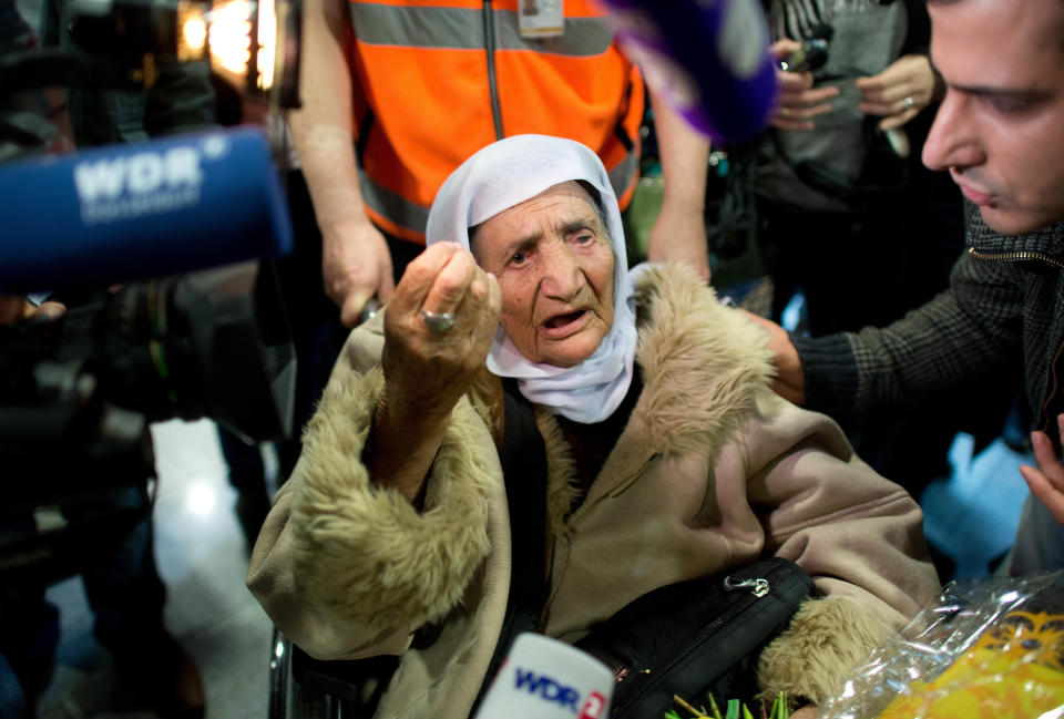 107-year-old Syrian Sabria Khalaf talks to reporters as she arrives at the airport in Duesseldorf, Germany, Monday, March 17, 2014. The woman who fled the conflict in Syria has been reunited with her family in Germany. German officials say Khalaf arrived from Greece where she had originally applied for asylum. (AP Photo/dpa, Federico Gambarini)