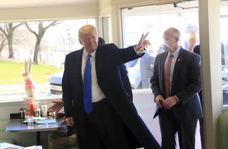 U.S. Republican presidential candidate Donald Trump greets guests as he stops in for breakfast at Miss Katie's Diner, while campaigning in Milwaukee, Wisconsin April 3, 2016. REUTERS/Darren Hauck
