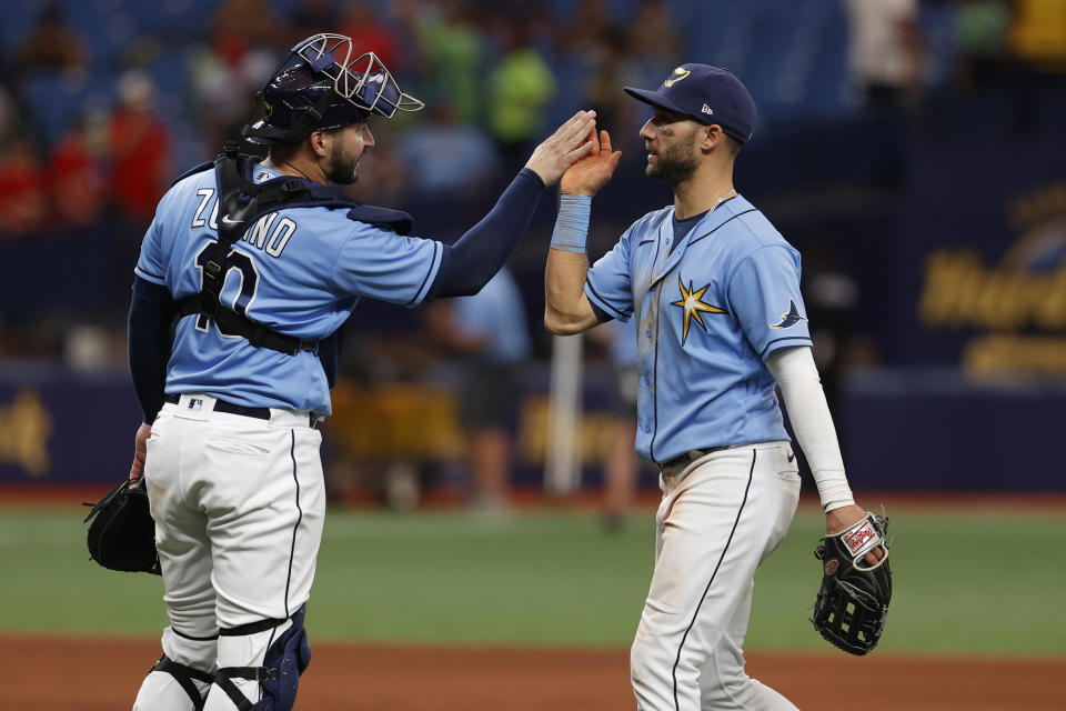 FILE - Tampa Bay Rays center fielder Kevin Kiermaier, right, celebrates with catcher Mike Zunino after defeating the Boston Red Sox in a baseball game April 24, 2022, in St. Petersburg, Fla. Rays standouts Kiermaier and Zunino are out for the season because of injuries, another significant blow for the defending AL East champions. (AP Photo/Scott Audette, File)