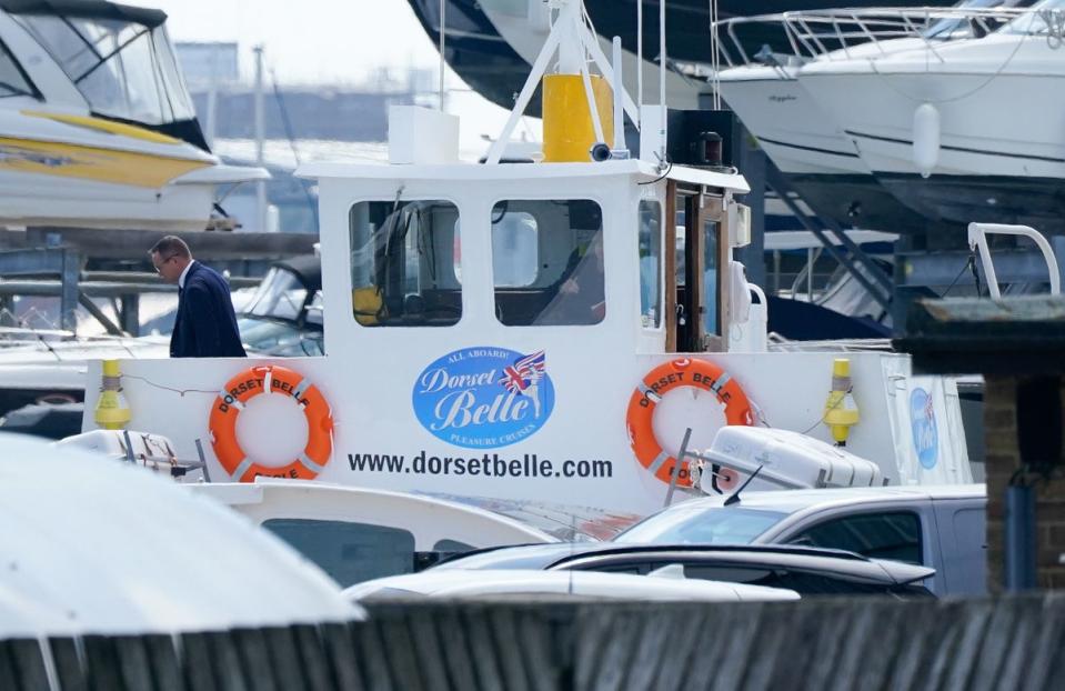 A group of people inspecting the cabin of the Dorset Belle cruise boat which has been impounded at Cobb’s Quay Marine (PA)